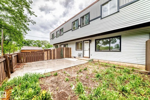 Multi-level exterior with light-colored siding and dark trim - 6117 120 Avenue, Edmonton, AB - Outdoor With Exterior
