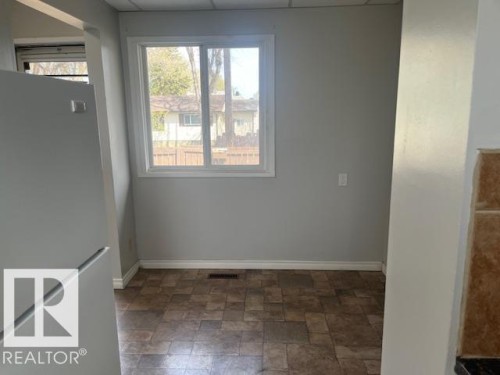 Light-filled interior space with neutral wall tones and a window offering outdoor views - 6117 120 Avenue, Edmonton, AB - Indoor Photo Showing Other Room