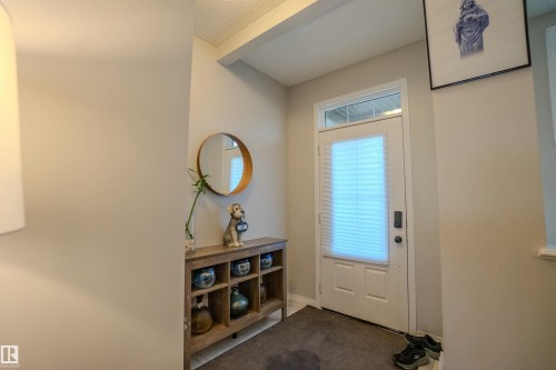 Entryway featuring a white door with an integrated privacy blind and transom window - 1766 Dumont Crescent Sw, Edmonton, AB - Indoor Photo Showing Other Room