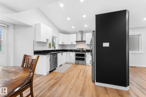 Modern kitchen featuring white cabinetry, dark countertops, and stainless steel appliances - 362 Blackburn Drive E, Edmonton, AB - Indoor