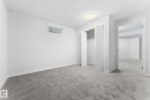 Neutral-toned carpeting and white walls in a bright interior room - 362 Blackburn Drive E, Edmonton, AB - Indoor Photo Showing Other Room