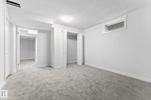 Spacious room featuring light gray carpeting, crisp white walls, and a recessed window - 362 Blackburn Drive E, Edmonton, AB - Indoor Photo Showing Other Room