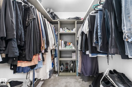 Walk-in closet featuring extensive built-in shelving and multiple hanging rods - 362 Blackburn Drive E, Edmonton, AB - Indoor With Storage