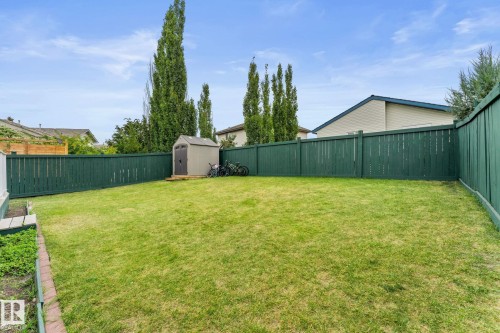 Expansive backyard featuring a manicured lawn, a full perimeter privacy fence, and a dedicated storage shed - 362 Blackburn Drive E, Edmonton, AB - Outdoor