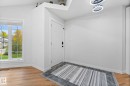Bright entryway featuring a white paneled door, wood-finish flooring, and a large multi-pane window - 362 Blackburn Drive E, Edmonton, AB  - Indoor Photo Showing Other Room 