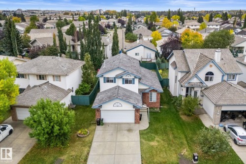 Traditional residence featuring a light-colored exterior with brick accents and blue trim details - 362 Blackburn Drive E, Edmonton, AB - Outdoor