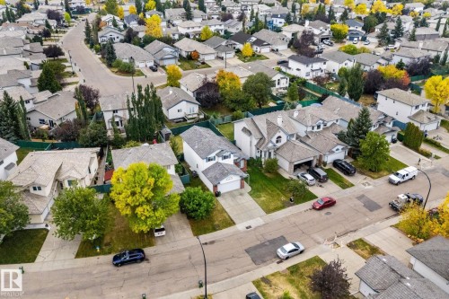 Residential street featuring detached properties with attached garages and mature landscaping - 362 Blackburn Drive E, Edmonton, AB - Outdoor With View
