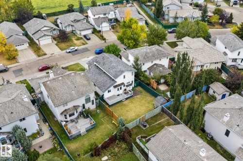Rear exterior featuring a multi-level deck, bay window, and a spacious green lawn - 362 Blackburn Drive E, Edmonton, AB - Outdoor With View
