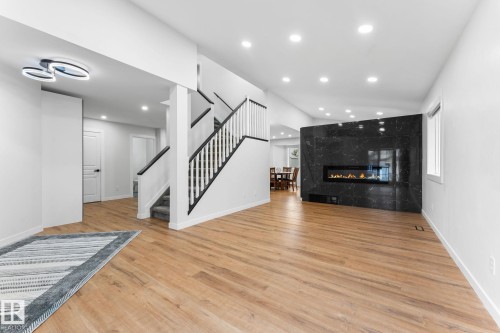 Spacious interior featuring wide plank wood-finish flooring throughout the main level - 362 Blackburn Drive E, Edmonton, AB - Indoor With Fireplace