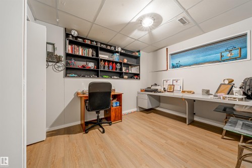 This room features light wood-look flooring and a drop ceiling with recessed lighting - 2437 89 Street, Edmonton, AB - Indoor Photo Showing Office