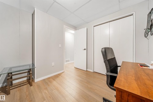This room features hardwood style flooring, light gray walls, and white trim - 2437 89 Street, Edmonton, AB - Indoor Photo Showing Other Room