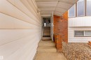 The property features a concrete walkway leading to the entrance, complemented by brick detailing and siding - 2437 89 Street, Edmonton, AB  - Outdoor With Exterior 