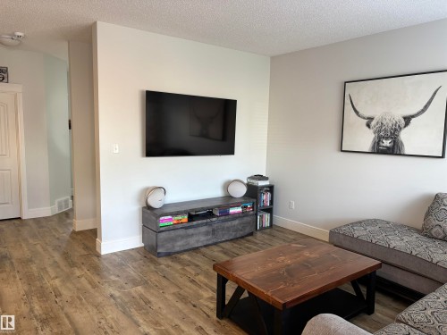 Spacious room featuring wood-finish flooring, light-toned walls, and white trim - 11 James Crescent, St. Albert, AB - Indoor Photo Showing Living Room