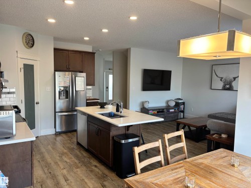 Open-concept living space featuring a kitchen with an island, stainless steel appliances, and recessed lighting - 11 James Crescent, St. Albert, AB - Indoor Photo Showing Kitchen With Double Sink