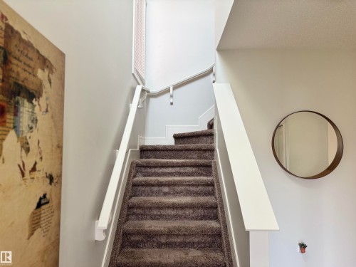 Carpeted staircase with white handrails and balusters - 11 James Crescent, St. Albert, AB - Indoor Photo Showing Other Room