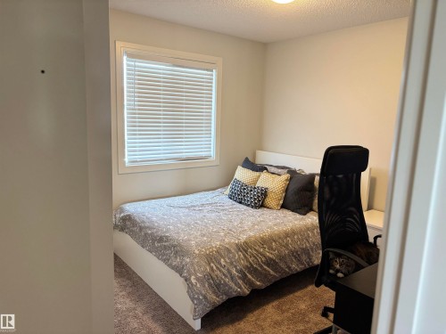 Room featuring a window with white blinds, neutral wall paint, recessed lighting, and carpet flooring - 11 James Crescent, St. Albert, AB - Indoor Photo Showing Bedroom