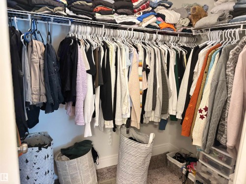 Corner closet featuring wire shelving and multiple hanging rods - 11 James Crescent, St. Albert, AB - Indoor With Storage