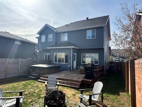 Expansive backyard featuring a multi-level wood deck, a built-in hot tub, and a surrounding privacy fence - 11 James Crescent, St. Albert, AB - Outdoor