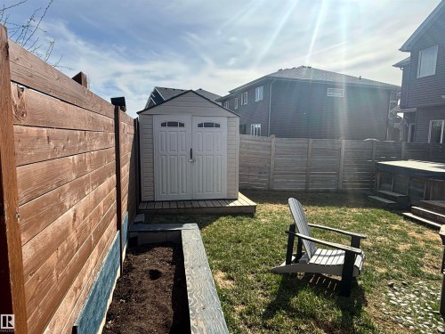 Backyard featuring a shed with double doors, wood fencing, and a raised garden bed - 11 James Crescent, St. Albert, AB - Outdoor With Exterior