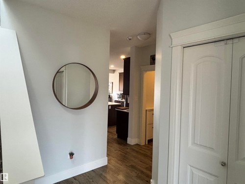 Interior hallway featuring wood-finish flooring and light-toned walls - 11 James Crescent, St. Albert, AB - Indoor Photo Showing Other Room