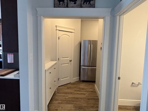 Hallway featuring wood-finish flooring and white trimwork - 11 James Crescent, St. Albert, AB - Indoor Photo Showing Other Room