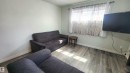 Room featuring wood-finish flooring, light-colored walls, and a window with white trim - 12139 81 Street, Edmonton, AB  - Indoor 