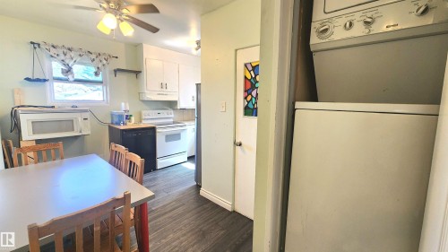 Bright kitchen space featuring wood-finish flooring and white cabinetry - 12139 81 Street, Edmonton, AB - Indoor Photo Showing Kitchen
