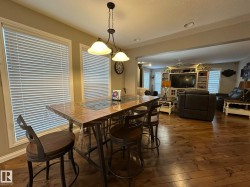 Hardwood-finish flooring throughout, featuring an open-concept layout - 
