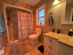 Bathroom featuring a white vanity with drawers, a light-colored countertop, and a built-in sink - 