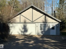 Gray siding with a light stucco gable featuring decorative trim - 
