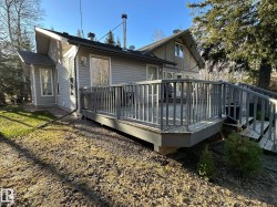 Rear deck featuring gray railings and steps - 