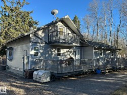 Two-story residence featuring light gray siding and complementary darker trim accents - 