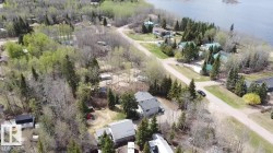 Aerial perspective showcasing multiple residential structures nestled within a wooded landscape - 