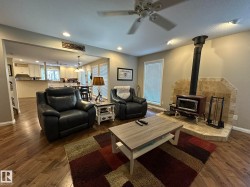 Living area featuring wood-finish flooring, recessed lighting, and a ceiling fan - 