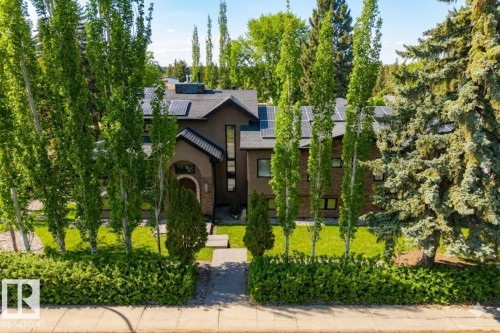 Multi-story residence featuring a dark exterior facade and an arched brick entryway - 11908 41A Avenue, Edmonton, AB - Outdoor