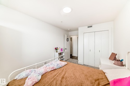 Room with white walls and a ceiling light fixture, featuring a closet with bi-fold doors - 307 9504 182 Street Nw, Edmonton, AB - Indoor Photo Showing Bedroom