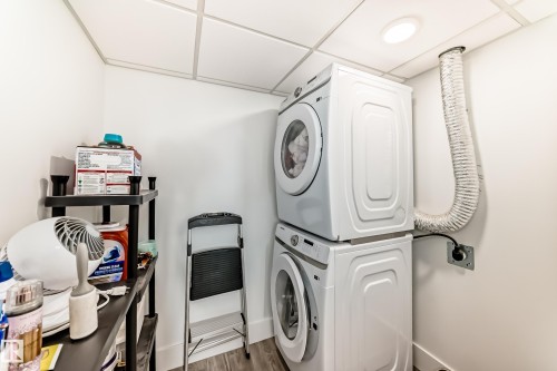 Laundry area with a stacked washer and dryer, recessed lighting, and light-colored walls - 307 9504 182 Street Nw, Edmonton, AB - Indoor Photo Showing Laundry Room