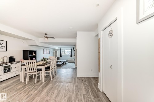 The property features light-colored flooring throughout, a dining area with a table and chairs, and a ceiling fan - 307 9504 182 Street Nw, Edmonton, AB - Indoor