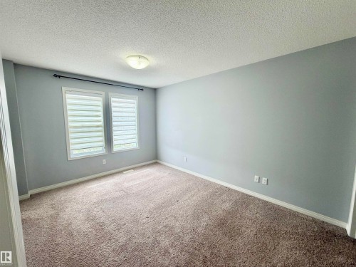 Room featuring two windows with horizontal blinds, light gray wall paint, and brown carpet flooring - 4310 Prowse Link Link, Edmonton, AB - Indoor Photo Showing Other Room