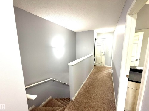 Upper landing with neutral carpeting and light gray walls - 4310 Prowse Link Link, Edmonton, AB - Indoor Photo Showing Other Room