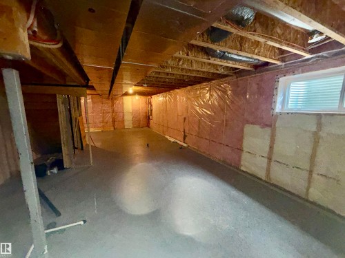 Unfinished basement with concrete flooring, framed window, and exposed ceiling joists - 4310 Prowse Link Link, Edmonton, AB - Indoor Photo Showing Basement