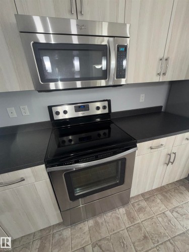 Stainless steel range with a glass cooktop and coordinating over-the-range microwave - 4310 Prowse Link Link, Edmonton, AB - Indoor Photo Showing Kitchen