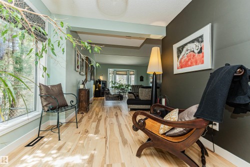 Expansive wood-finish flooring creating continuity throughout, large picture windows, and recessed lighting - 1235 104 Street, Edmonton, AB - Indoor Photo Showing Other Room