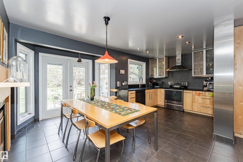 Contemporary kitchen with dark floor tiles and light wood-finish cabinetry - 1235 104 Street, Edmonton, AB - Indoor