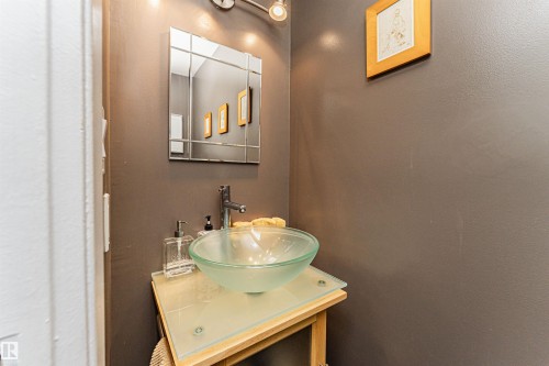 Pedestal-style vanity with a glass top and clear vessel sink - 1235 104 Street, Edmonton, AB - Indoor Photo Showing Bathroom