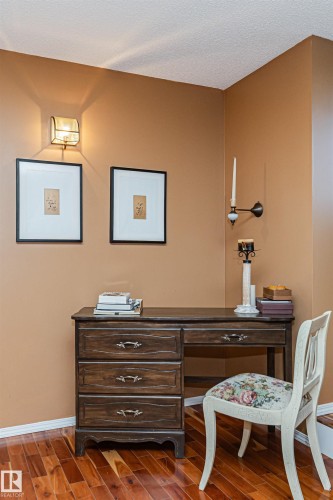 Warm wood-finish flooring complements the wall tones in this inviting corner - 1235 104 Street, Edmonton, AB - Indoor