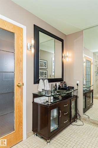 Wood vanity with glass countertop and vessel sink - 1235 104 Street, Edmonton, AB - Indoor Photo Showing Bathroom
