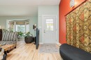Entryway featuring a white door with decorative glass inserts, wood-finish flooring, and a bay window with window treatments - 1235 104 Street, Edmonton, AB  -  Photo Showing Other Room 