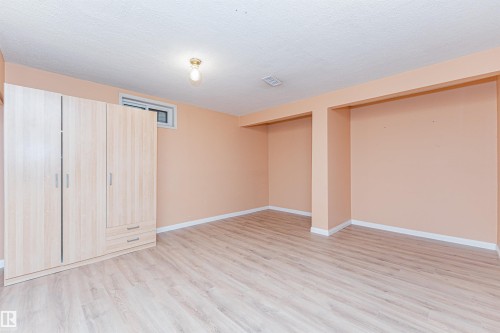 Spacious room with light wood-finish flooring and neutral wall tones - 1235 104 Street, Edmonton, AB - Indoor Photo Showing Other Room