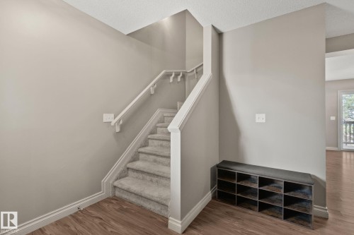 Carpeted staircase with white handrails and risers - 46 445 Brintnell Boulevard, Edmonton, AB - Indoor Photo Showing Other Room